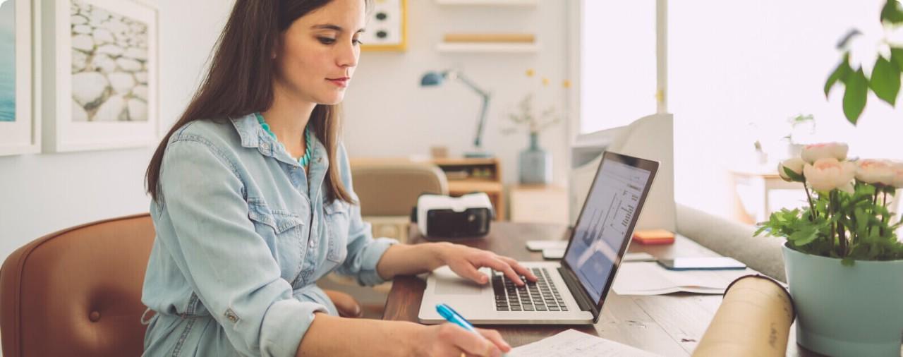 Expecting woman working on a laptop